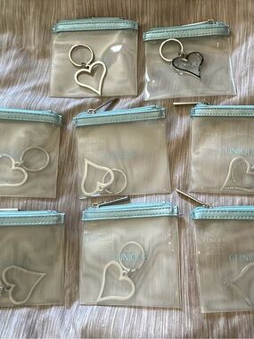 8 Clinique Clear Vinyl Coin Pouch with Light Blue Trim and Silver Heart Keyring